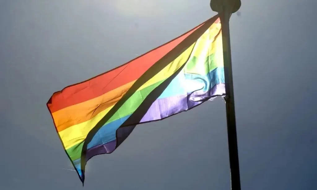 Bandeira arco-íris do movimento LGBTQIA+ hasteada ao vento. (Foto: cartacapital.com.br)